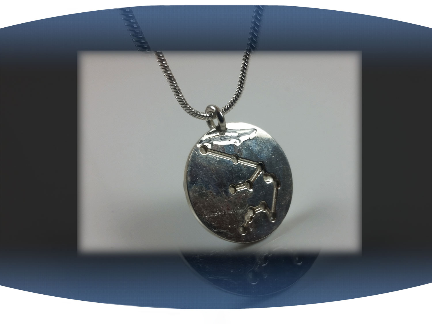 Close up of back of aquarius zodiac pendant showing aquarius star constellation